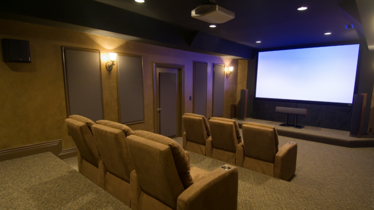 A luxurious home theater with rows of recliner seating and a large projector screen.