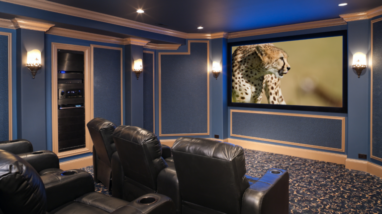 A luxurious home theater with plush carpets and leather reclining chairs.