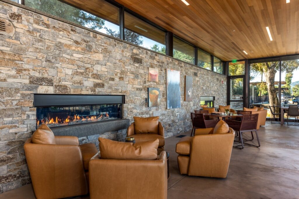 A commercial dining area with in-ceiling lighting and a modern fireplace.