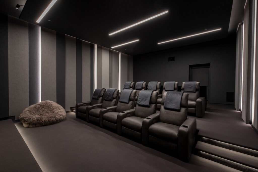 A view of a home theater with rows of comfortable chair seating.