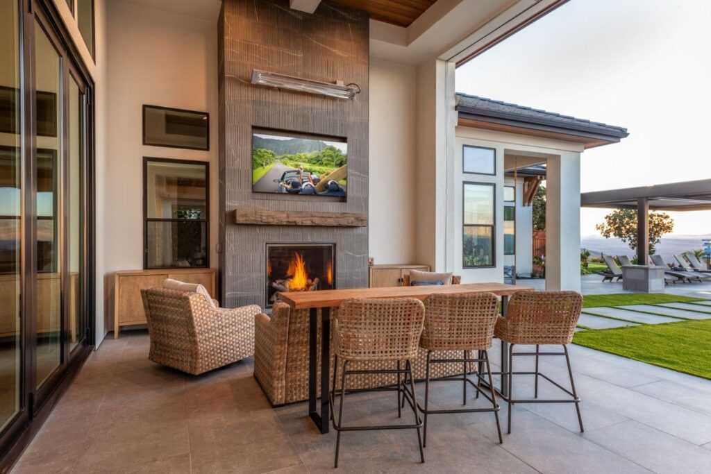 A bench table on a patio with open air and sunlight.