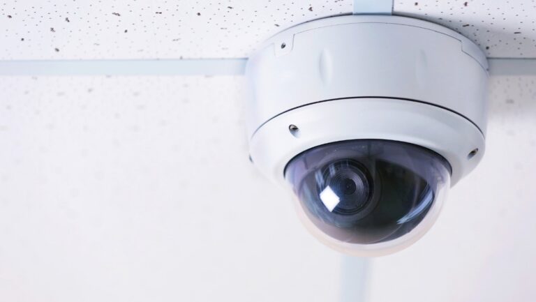 A close-up image of a dome security camera in an office.