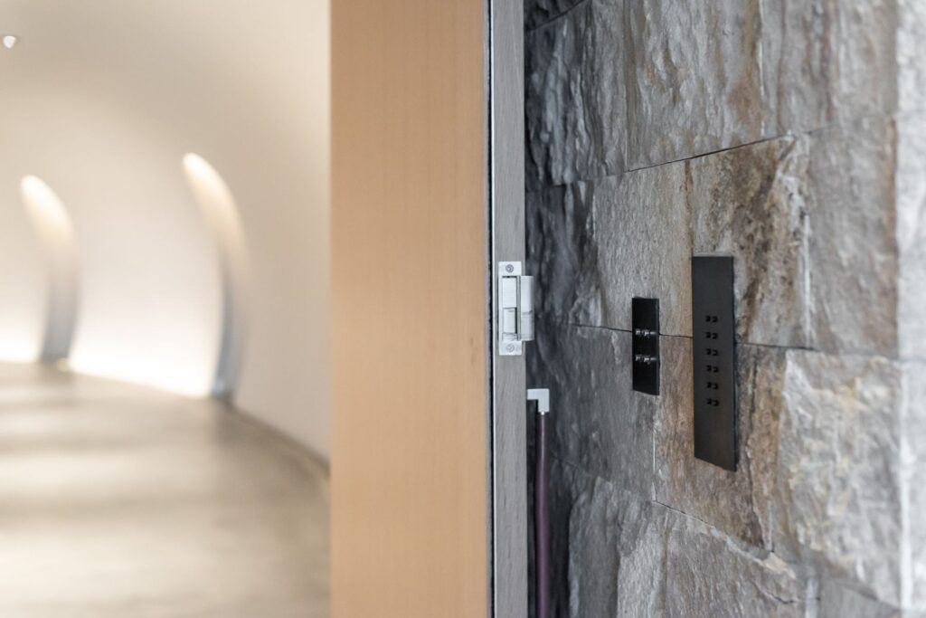 A custom subtle home automation controller installed into a stone wall.