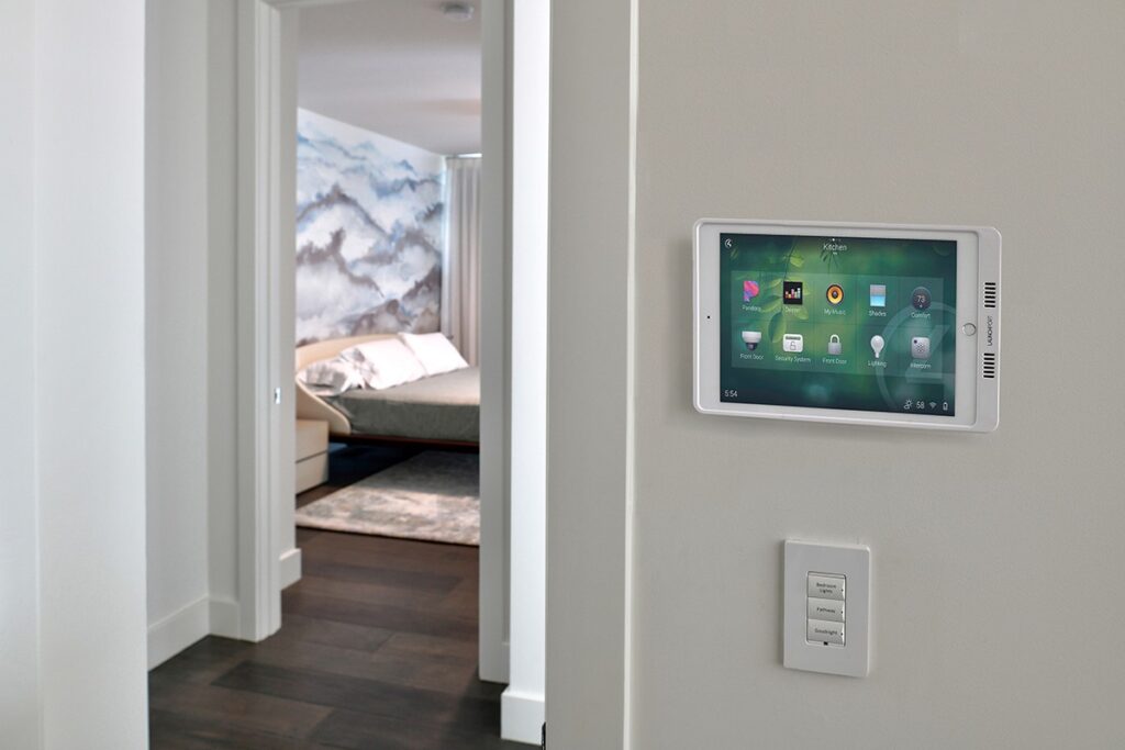 A digital smart home automation control panel installed into a wall.