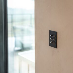 A subtle smart home automation control panel on a wall.