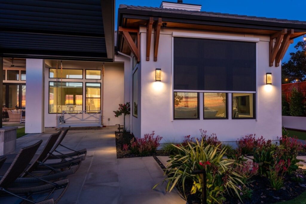 The window of a luxury home with the shades lowered.