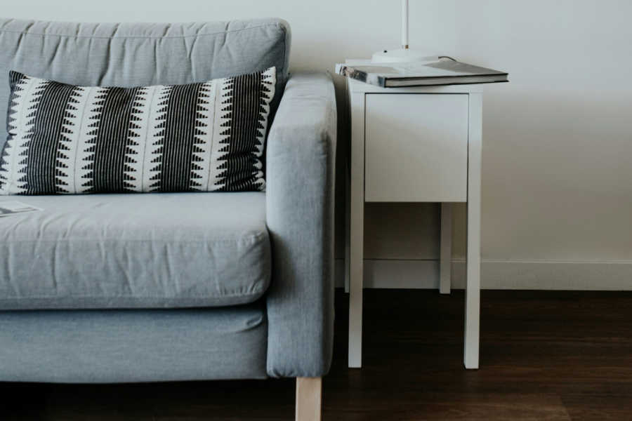 a lamp on a table next to a couch